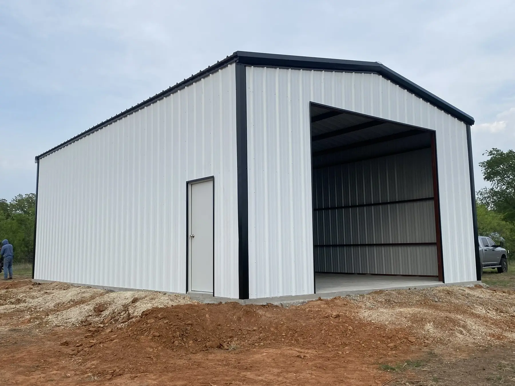 White barndominium with black trim — built by Rodriguez Metal Buildings, Central Texas