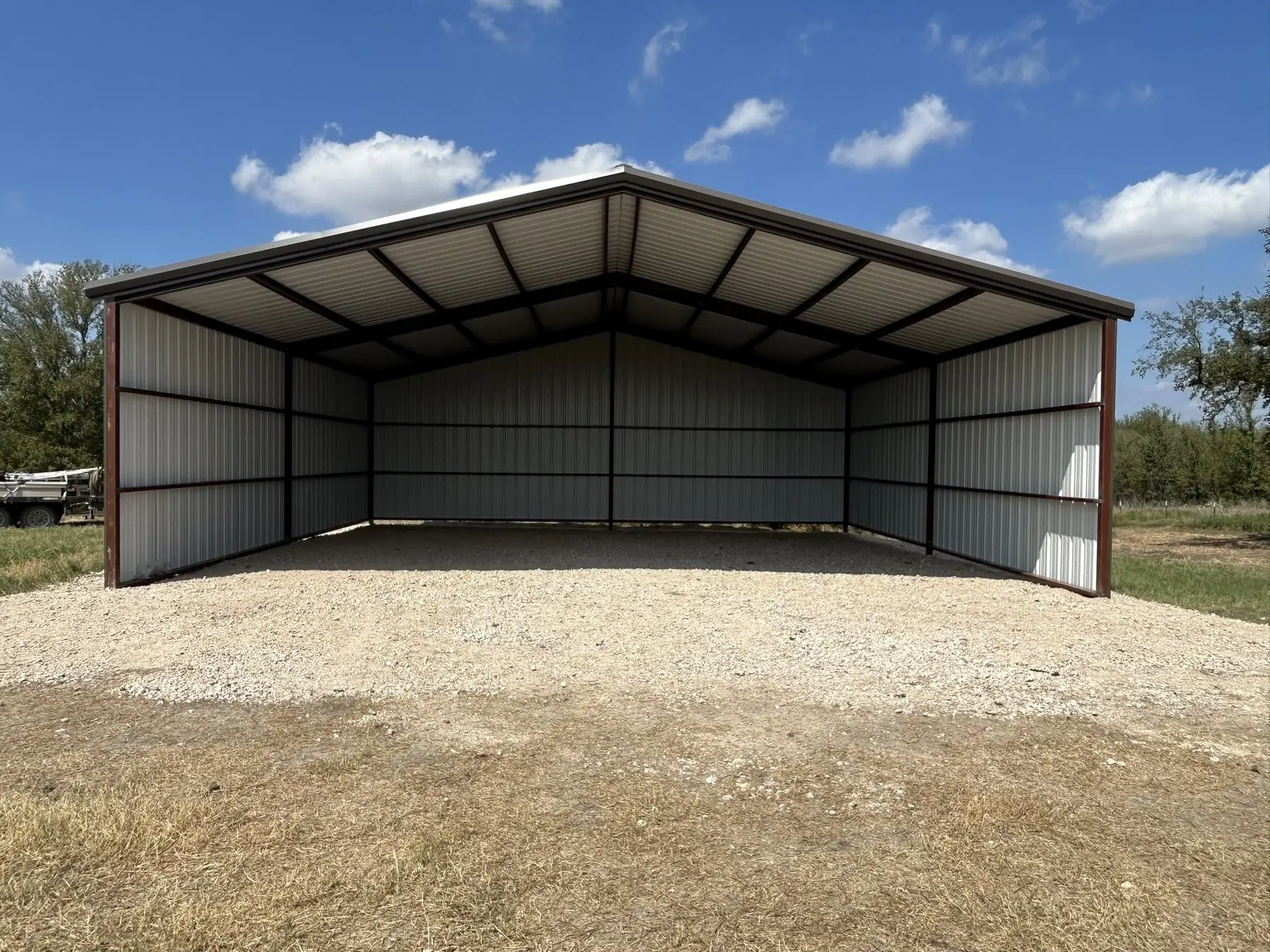 Two-bay carport with charcoal trim — built by Rodriguez Metal Buildings, Central Texas