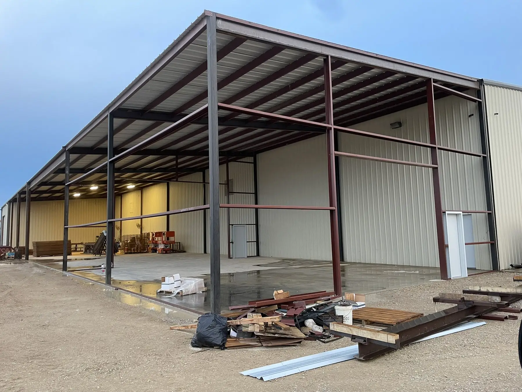 Commercial frame from inside, mid-build — built by Rodriguez Metal Buildings, in progress