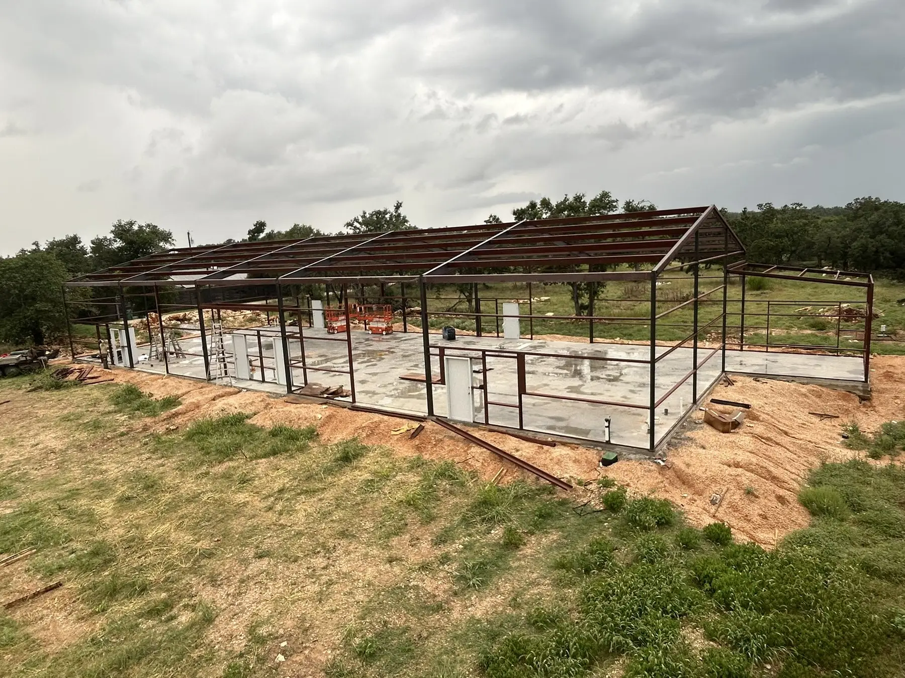 Frame raised in an open field — built by Rodriguez Metal Buildings, in progress