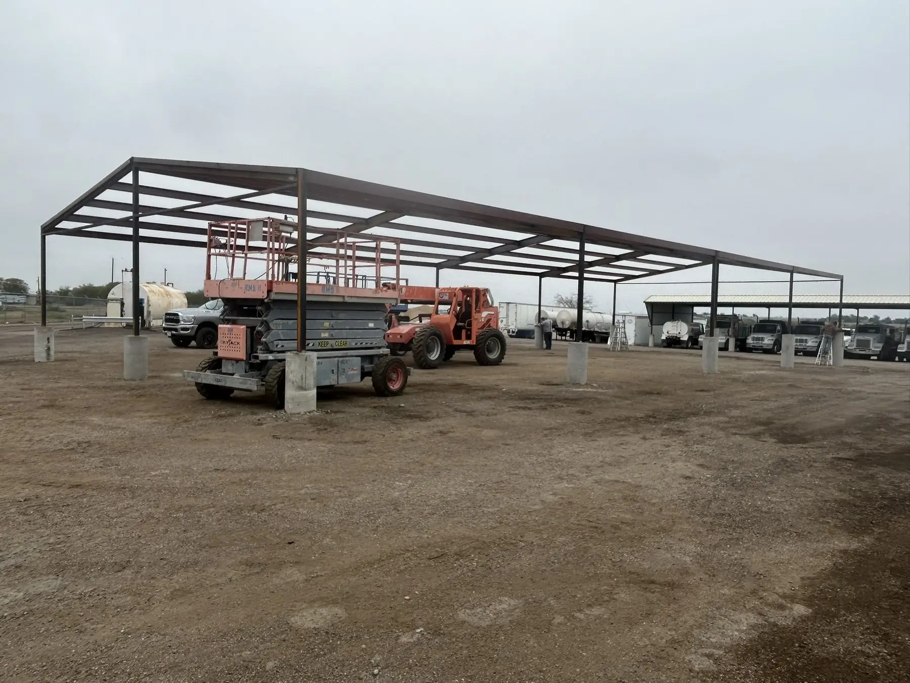 Equipment pavilion over a working yard — built by Rodriguez Metal Buildings, Central Texas