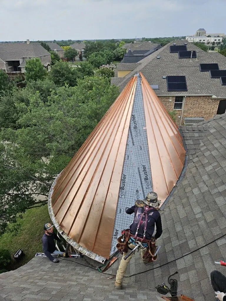 Copper standing seam roof on a conical turret, installed by RMB