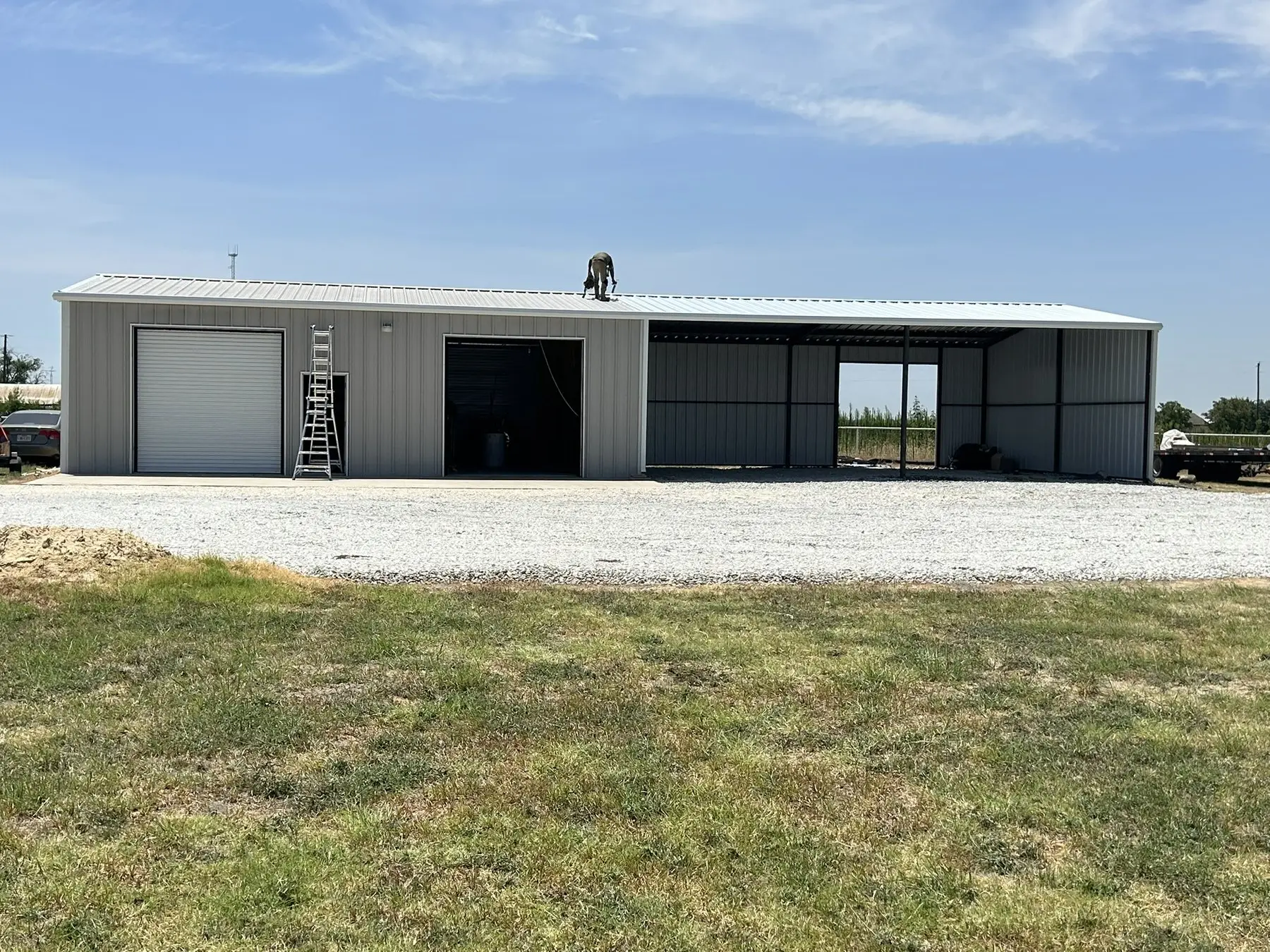Grey shop sized around the equipment inside — built by Rodriguez Metal Buildings, Central Texas